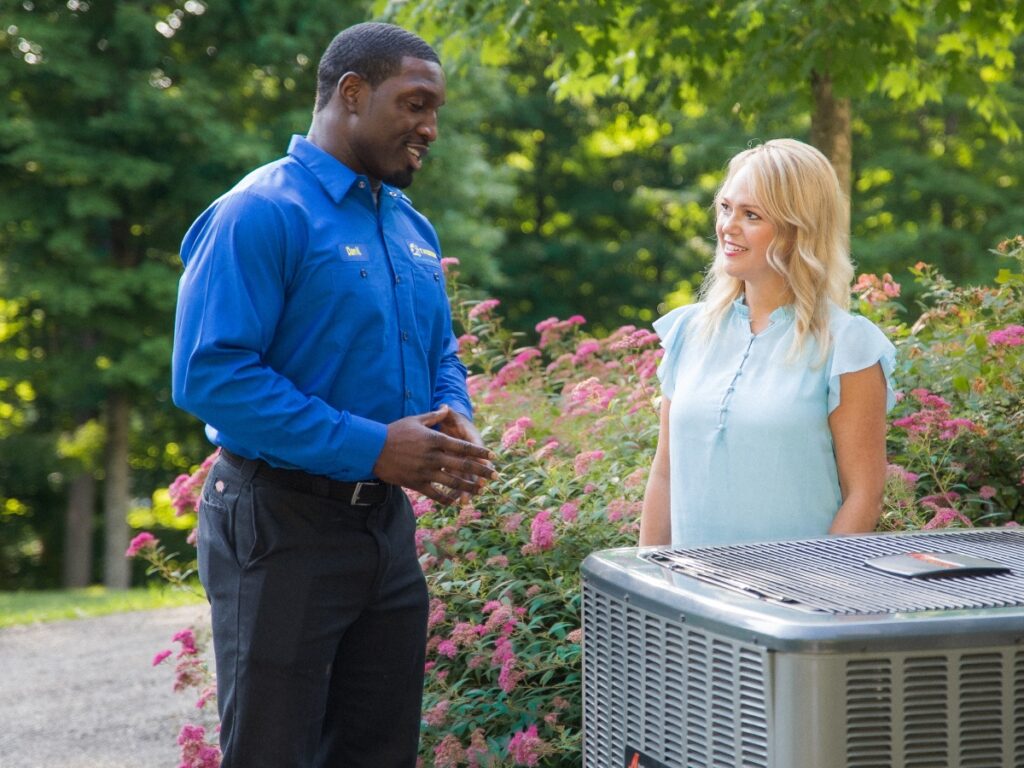 T. Webber HVAC technician discussing air conditioning repair services